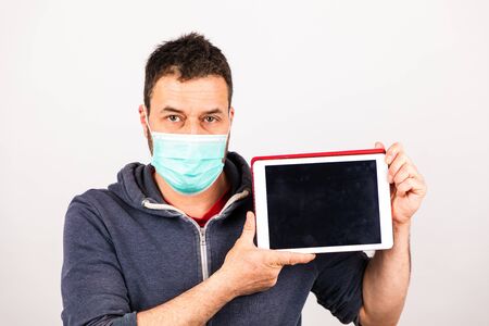 man with a mouthguard isolated against white background with tabletの写真素材