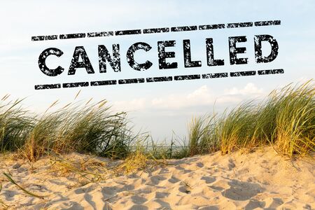 dunes on sunny day and text cancelled - holiday cancelの写真素材
