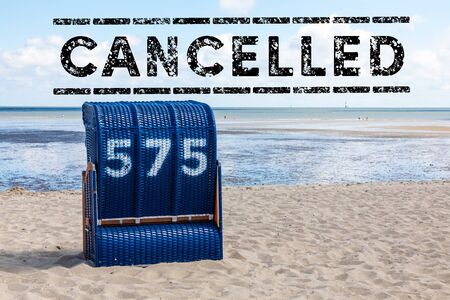 beach with beach chair and text cancelled - holiday cancelの写真素材
