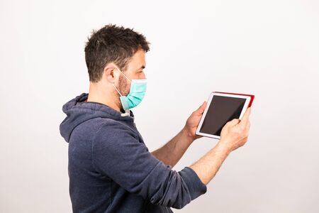 man with a mouthguard isolated against white background with tabletの写真素材
