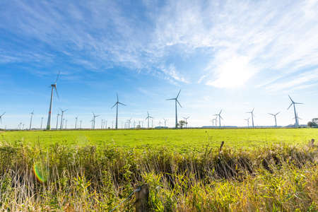 DORNUM, GERMANY - OCTOBER 10, 2019: Enercon wind turbines in a field with blue sky