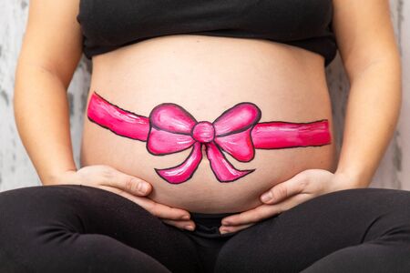 pregnant woman with colorful painted baby bump