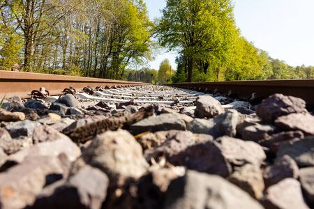 Railway tracks in nature with blue skyの写真素材