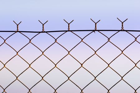top of wire fence against soft dusk sky
