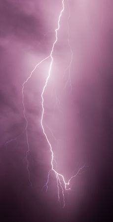 single lightning bolt in stormy purple night sky