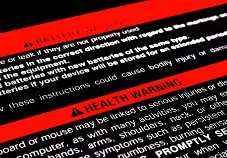 health warning on the back of a computer keyboardの写真素材