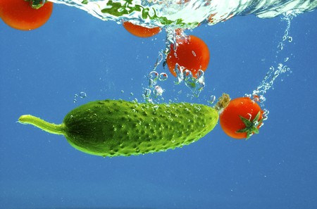 A series, vegetables in water on a dark blue backgroundの写真素材