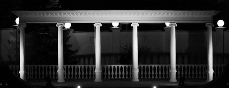 Antique columns with the green illumination, at night