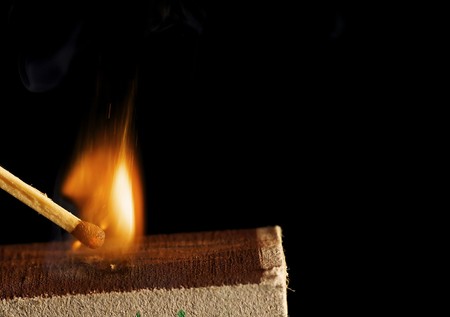 The wooden match is lighted from a boxの写真素材