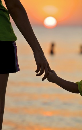 The small daughter holds mum by the hand on a declineの写真素材