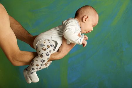 Supporting Hands. Father holding his 3 month old baby boy on his arms の写真素材