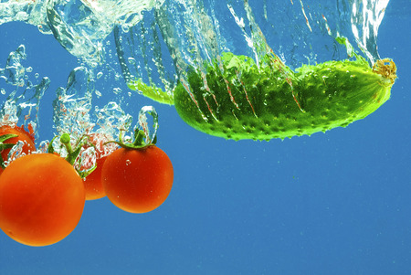 A series, vegetables in water on a dark blue backgroundの写真素材