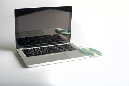 Laptop and CD on backgroundの写真素材
