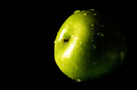 Green apple with water dropletsの写真素材