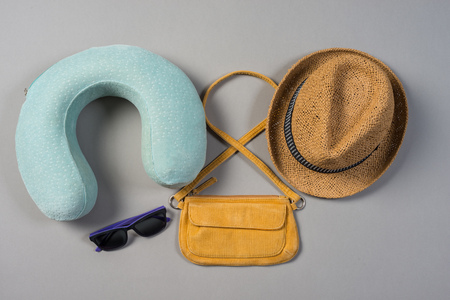 Packed suitcase of vacation items on grey background, top viewの写真素材