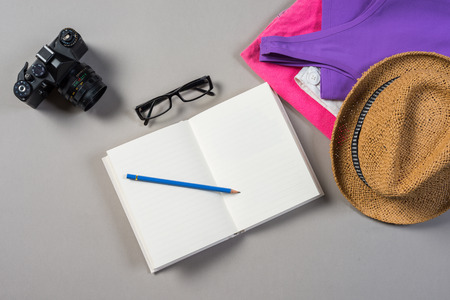 Mock up of summer traveling stuff on grey background.