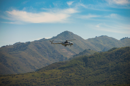 Helicopter flying over mountainsの写真素材