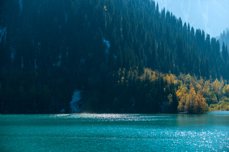 Autumn photo after snowfall, mountain lake Issyk in Almaty region, Kazakhstan. October.