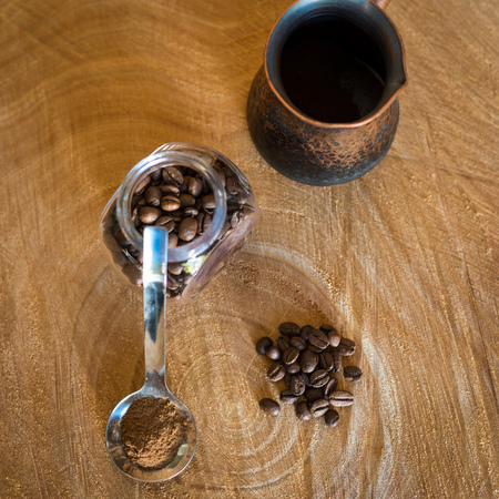 Coffee beans on a wooden tableの写真素材