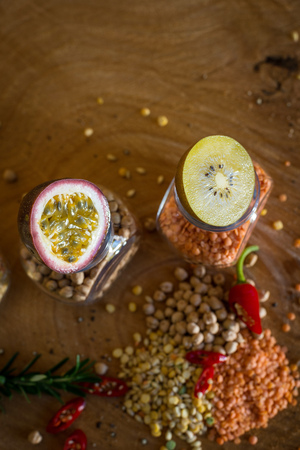 Raw cereals set and fruit (Lemon, Kiwi and Passion fruit) on wooden background.の写真素材