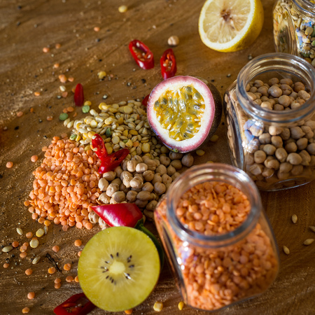 Raw cereals set and fruit (Lemon, Kiwi and Passion fruit) on wooden background.の写真素材