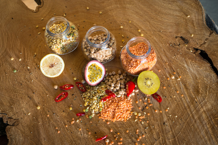 Raw cereals set and fruit (Lemon, Kiwi and Passion fruit) on wooden background.の写真素材