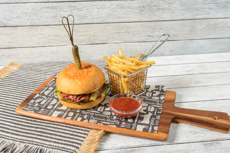 A beef burger is a classic American dish consisting of a ground beef patty, seasoned and grilled, served on a bun.の写真素材