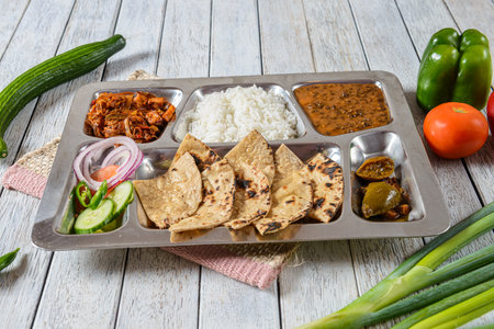 A Punjabi Thaali is a traditional meal from the Punjab region of India, known for its rich and diverse flavors. It typically consists of a variety of dishes served together on a large platter.の写真素材