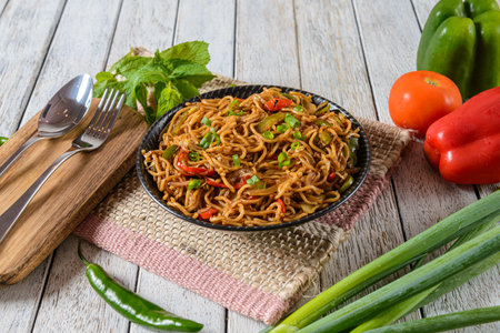 Veggie Hakka Noodles is a popular Indo-Chinese dish consisting of stir-fried noodles mixed with a variety of colorful vegetablesの写真素材