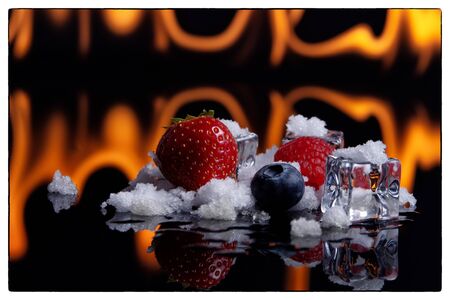 Fruits in Ice cubes over white at fire in backgraundのeditorial素材