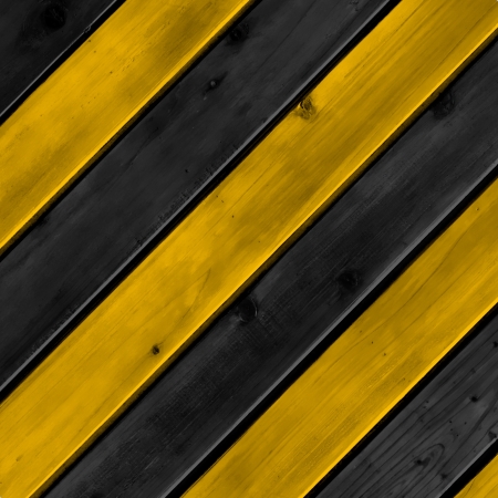 Yellow and black denger lines with wood boardの写真素材
