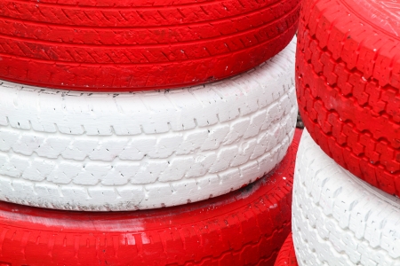 Pile red and white rubber tires for backgroundの写真素材