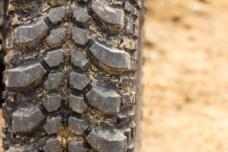 Tread tire coated in mud on an offroad