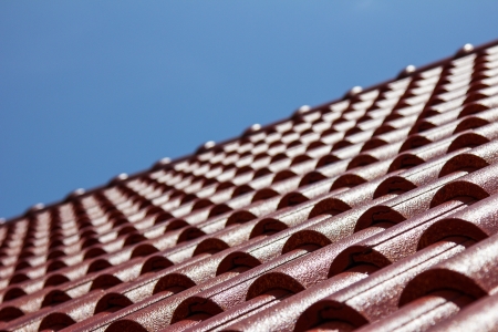 Closeup red roof top and blue skyの写真素材