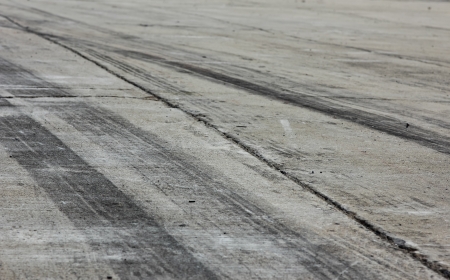 Background with tire marks on road trackの写真素材