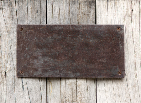 Metal sign on wood plank backgroundの写真素材