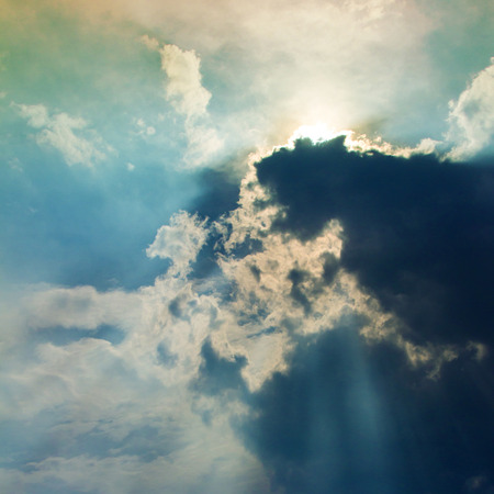 View of clouds in sky with rays of lightの写真素材