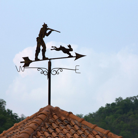 Weather vane with blue skyの写真素材