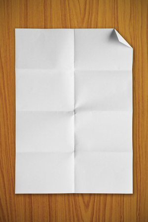 Blank white paper on a wooden backgroundの写真素材