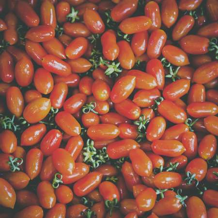 Fresh red tomato background in the marketの写真素材