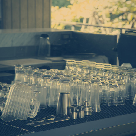 Bartender tools and glass on bar counter