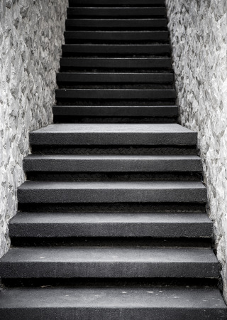 Narrow staircase with stone wall, vintage filter