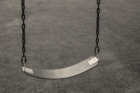 Empty swing for kid hang at playgroundの写真素材