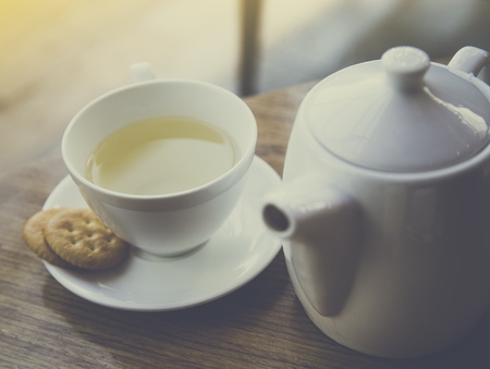 Tea with teapot and cookie on wooden tableの写真素材