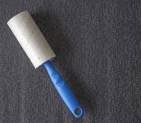 Dirty roller for cleaning on fabric backgroundの写真素材