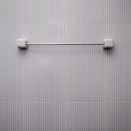 Steel towel holder on wall in bathroomの写真素材