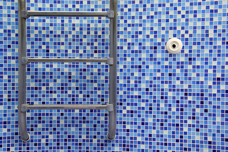 Empty swimming pool with stainless steel stairの写真素材