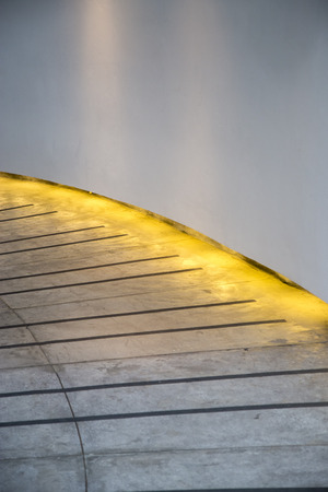Walkway curved with light under wallの写真素材