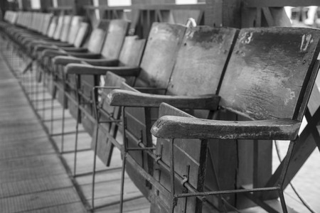 Empty old wooden chairs standing in a rowの写真素材