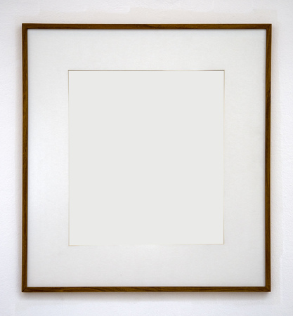 Blank photo frame at the wallの写真素材